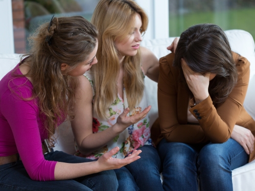 Three woman comforting friend