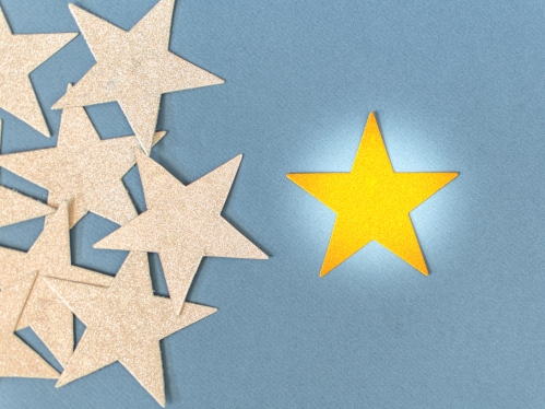 bright gold star next to multiple gold stars
