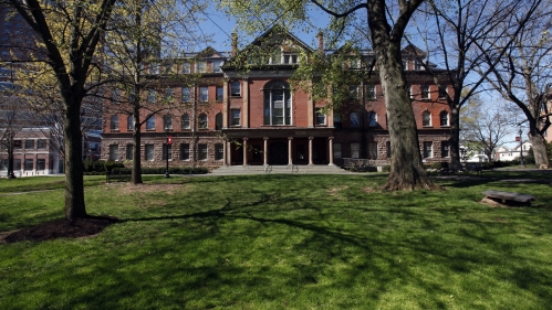 Green lawn with Campus building in the background; spring