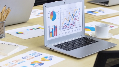 laptop showing data on work table