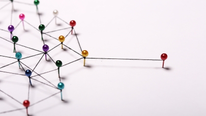 Image of pins making a network out of string with one pin extended to the right