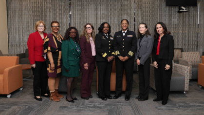 Rear Adm. Jennifer Moon with a colleague and School of Social Work faculty and staff