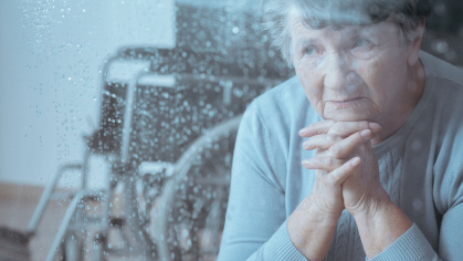 Older adult looking out of a window