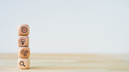 Wooden blocks stacked with images of research and ideas