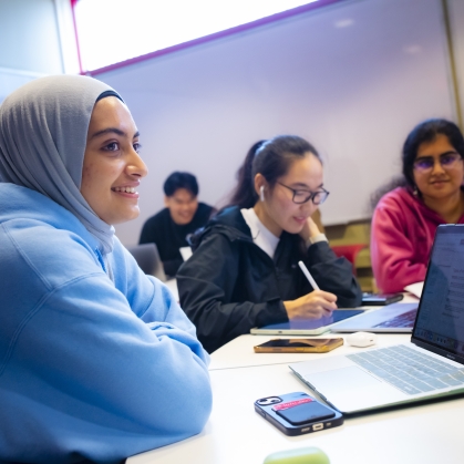 Zehra Jaffri (SAS '24), Ruofan Chen (SOE '25), and Sahana Ranganathan (SOE '25) use their laptops to study in the Busch Learning Center