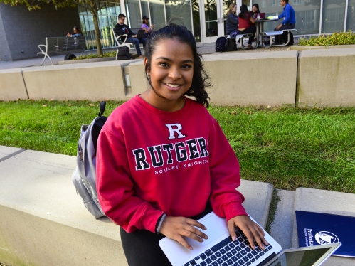 Student typing on laptop