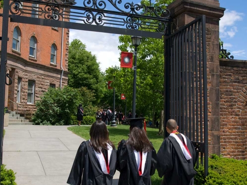 Students walking under arch