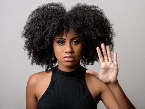 Woman signaling stop with her hand.