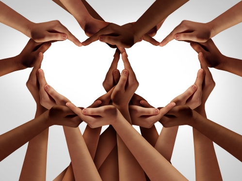 Many hands shaping two hearts