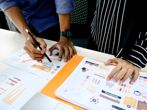 two colleagues reviewing data on paper