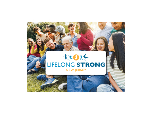 Intergenerational group sitting on grass with organizational logo overtop